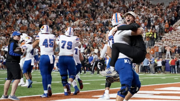 Kansas celebrates their 57-56 upset win over the Longhorns in Austin in 2021